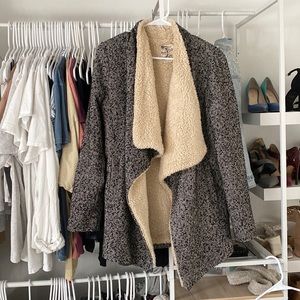 Black and white jacket with Sherpa on the inside.